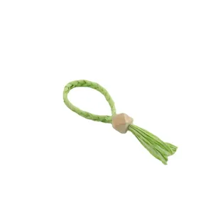 Handmade woven paper napkin ring with wooden bead and tassel for table decor and dining.