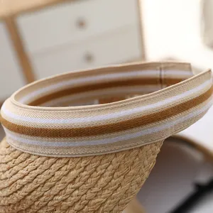 Detail view of summer woven straw sun visor hat with striped elastic band, raffia material.