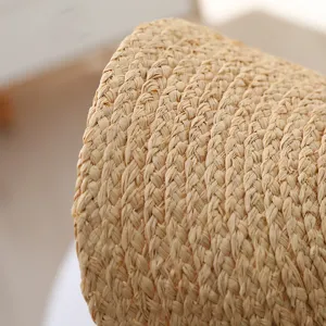 Close-up detail of handmade raffia straw weave texture for sun protection beach hat summer.