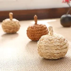 Handmade straw woven pumpkin crafts decorative ornaments for autumn harvest and Christmas decor.