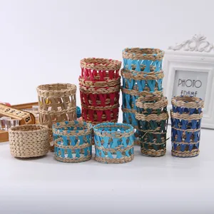 Woven straw cup sleeve and bottle holder decorative handmade braided vase cover tabletop display.
