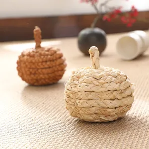 Handmade straw woven pumpkin decorative craft ornament for autumn home decor and holiday display.