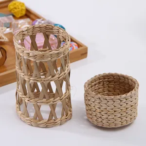Detailed shot of handmade straw woven cup sleeve and small storage basket, natural texture.
