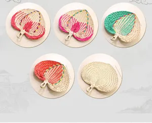 Detailed view of handmade woven straw fans, traditional Chinese style summer palm leaf cooling fan.
