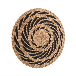 Natural woven round wall hanging decorative mat with black spiral pattern for home decor