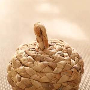 Handmade straw woven pumpkin ornament detail view, natural plant fiber Christmas decor craft.