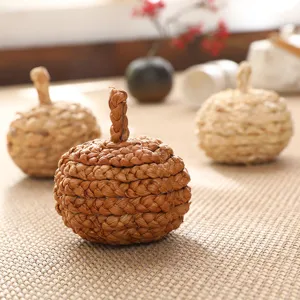 Close-up detail of hand-woven straw pumpkin craft decor for autumn and holiday tabletop displays.