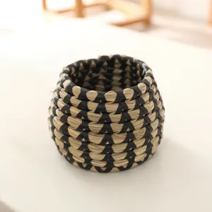 Handmade woven seagrass plant pot cover, natural straw storage basket detail view.