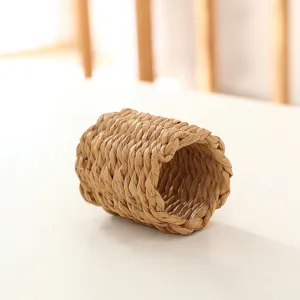 Handcrafted woven napkin ring detail, natural straw texture for elegant rustic dining table decor.