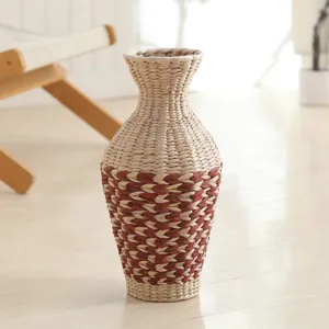 Handmade woven grass vase with big belly design for cozy home desktop and dry flower styling.
