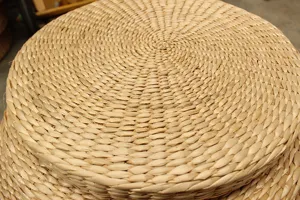 Handwoven straw pouf cushion detail, natural round tatami meditation pad for yoga and home decor.