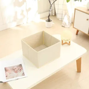 Beige foldable fabric storage box detail, canvas storage basket for home organization.