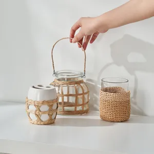 Handmade straw woven glass bottle cover set, elegant bathroom decor and home storage accessories.