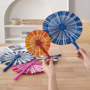 Handmade woven straw fan detail shot, colorful handheld raffia fan for summer home decor.