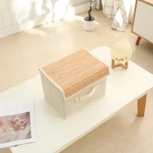 Detail shot of the foldable fabric storage box featuring a natural bamboo lid placed on table.