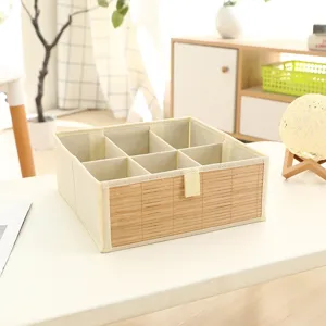 Detailed view of the foldable fabric storage box with multi-grid dividers and bamboo panel.