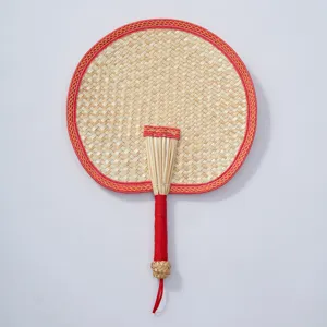 Handwoven straw fan detail, traditional Chinese style round design with red border and handle wrap.