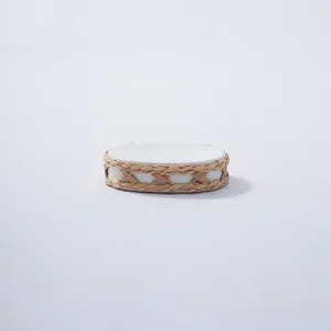 Handmade woven straw wrapped ceramic base detail close-up, natural rustic home decor element.