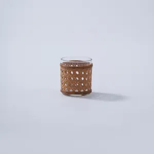 Handmade rattan woven glass vase detail shot, retro desktop hydroponic flower pot decorative cover.