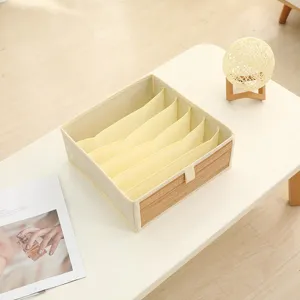 Detailed view of multi-compartment fabric storage organizer box with bamboo front panel