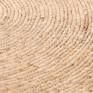 Handcrafted woven natural fiber round rug detail, rustic bohemian style home floor decor.