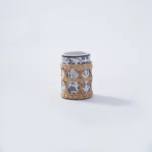 Handcrafted ceramic cup with natural woven straw sleeve, blue and white floral decor home vase.
