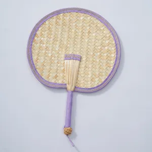 Hand-woven bamboo fan detail shot, featuring neat purple edge binding and comfortable handle.