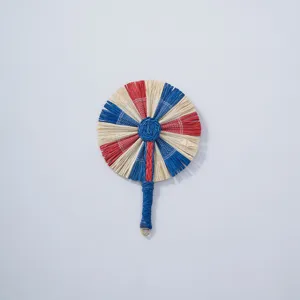Handmade straw fan detail view, traditional woven pattern in red, blue, and white colors.