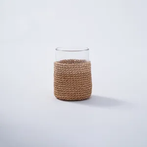 Detailed product showcase of a handmade natural woven rattan glass cup protective cover