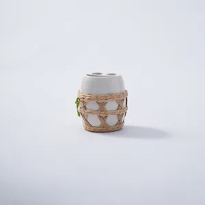 Handmade straw woven bottle mesh sleeve, ceramic cup protective cover detail view.