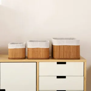 Detailed view of pastoral style woven bamboo storage baskets with white fabric inner lining.