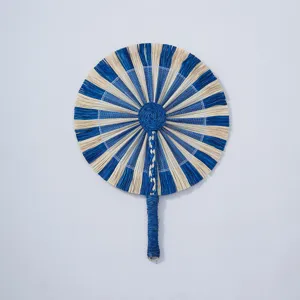 Handmade woven fan detail, blue and white straw pattern, natural craftsmanship texture.