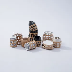 Detailed view of various ceramic and glass bottles with natural straw woven covers.