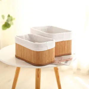 Detailed view of pastoral style bamboo woven storage basket with fabric liner for home desktop organization.