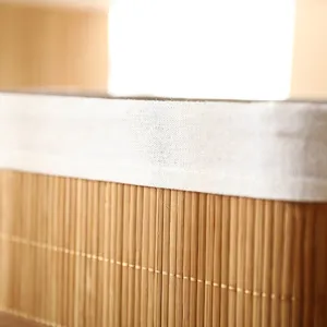 Close-up detail of bamboo woven storage basket with white fabric lining for home decor.