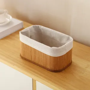 Close-up detail of the pastoral style bamboo woven storage basket with fabric liner for desktop tidy.