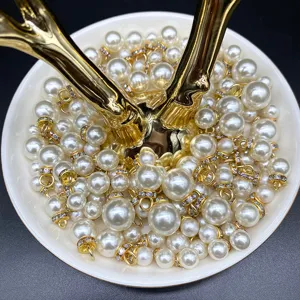 Close-up detail of DIY faux pearl charms with rhinestone gold caps for handmade crafts jewelry