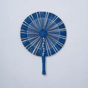 Detailed close-up of handmade blue straw fan, showing intricate woven texture and natural craft.