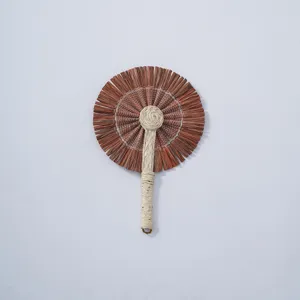 Handcrafted natural woven straw hand fan detail, traditional summer cooling accessory.