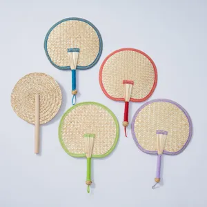 Handmade woven straw fan with colorful edging, traditional Chinese style summer cooling tool.