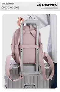 Pink nylon travel backpack detail showing luggage strap and comfortable casual daily use style.