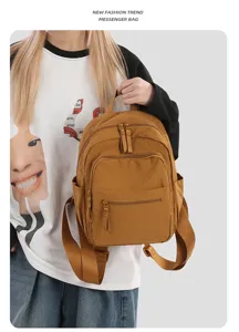 Detailed view of the casual brown nylon backpack featuring multiple zipped pockets and straps.