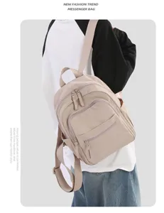Detail view of lightweight nylon casual backpack featuring multiple zippered pockets.