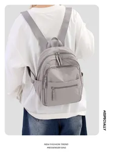 Detail view of the lightweight casual nylon backpack with multiple zipper pockets and side slots.