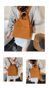 Detail view of a stylish brown backpack with comfortable straps for daily commuting and travel.