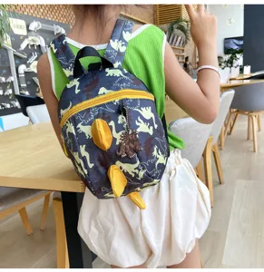 Baby dinosaur backpack with anti-lost leash, cute cartoon toddler school bag detail view.