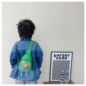 Detailed view of cute children chest bag in vibrant green with adorable cartoon bear design for kids.
