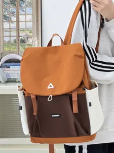 Backpack detail view showing contrast color design, multi-pocket canvas material, daily use.