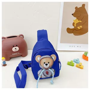 Detailed view of cute children blue chest bag with stylish bear print and adjustable strap.