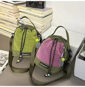 Casual outdoor small shoulder bag, stylish crossbody pouch with cute tennis racket pendant.